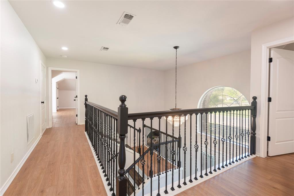 2020 Arbor Bend Road Bonham, TX 75418 - Photo 30 of 40 Corridor featuring an upstairs landing, light wood-type flooring, and a chandelier