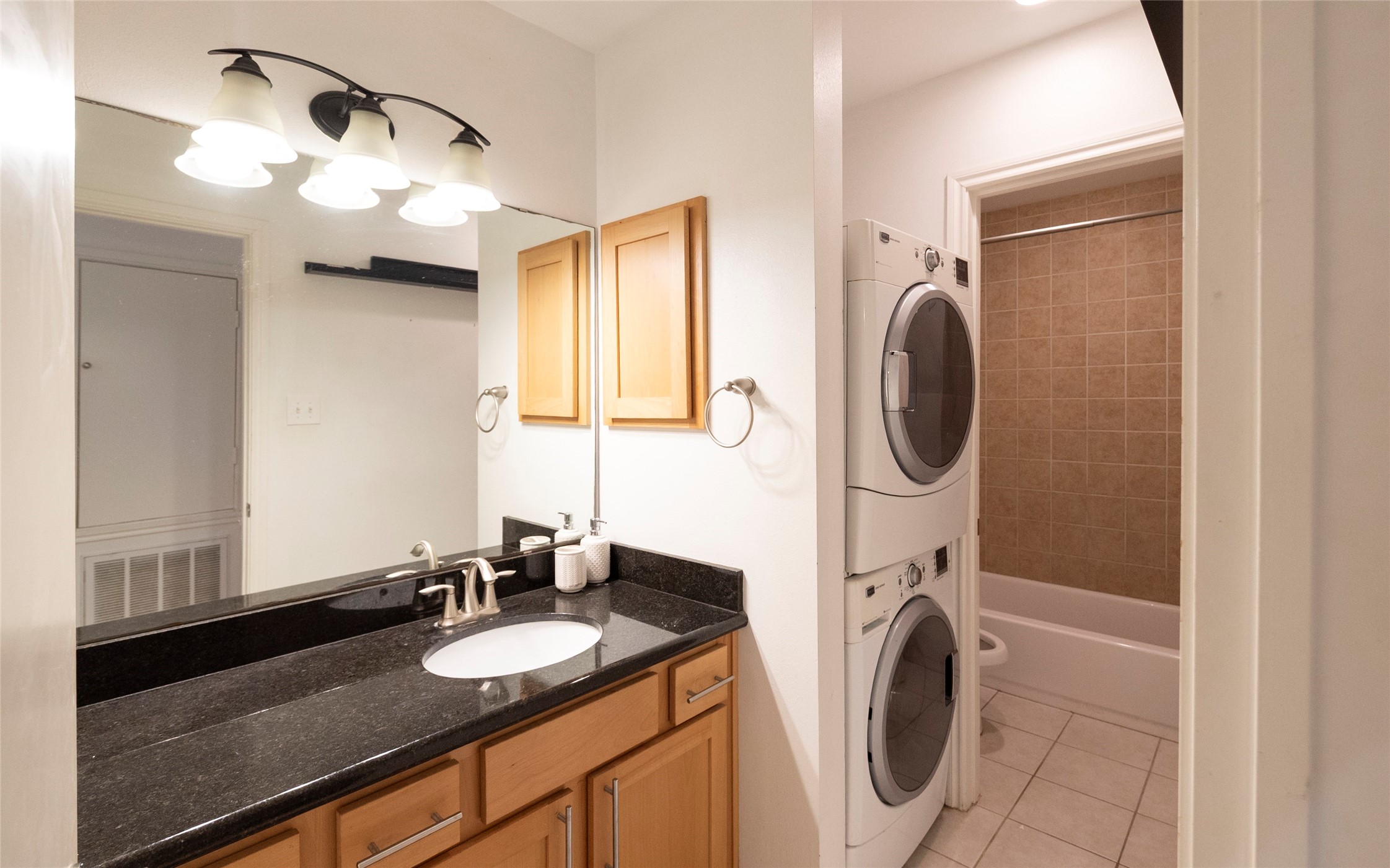 1100 Augusta Drive, Unit 76 Houston, TX 77057 - Photo 10 of 12 a bathroom with a sink and a mirror