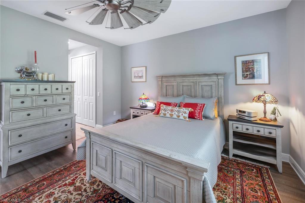 2167 Marquesa Circle Naples, FL 34112 - Photo 11 of 21 a bedroom with a bed and a chandelier