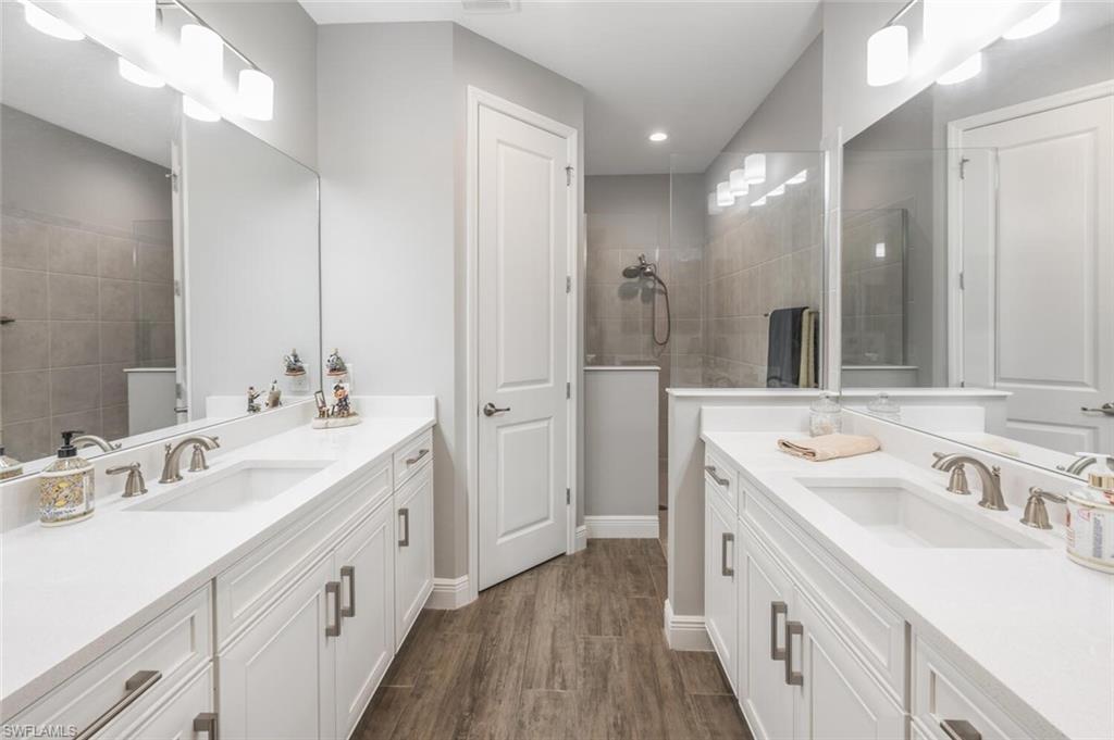 2167 Marquesa Circle Naples, FL 34112 - Photo 12 of 21 a spacious bathroom with a double vanity sink mirror and