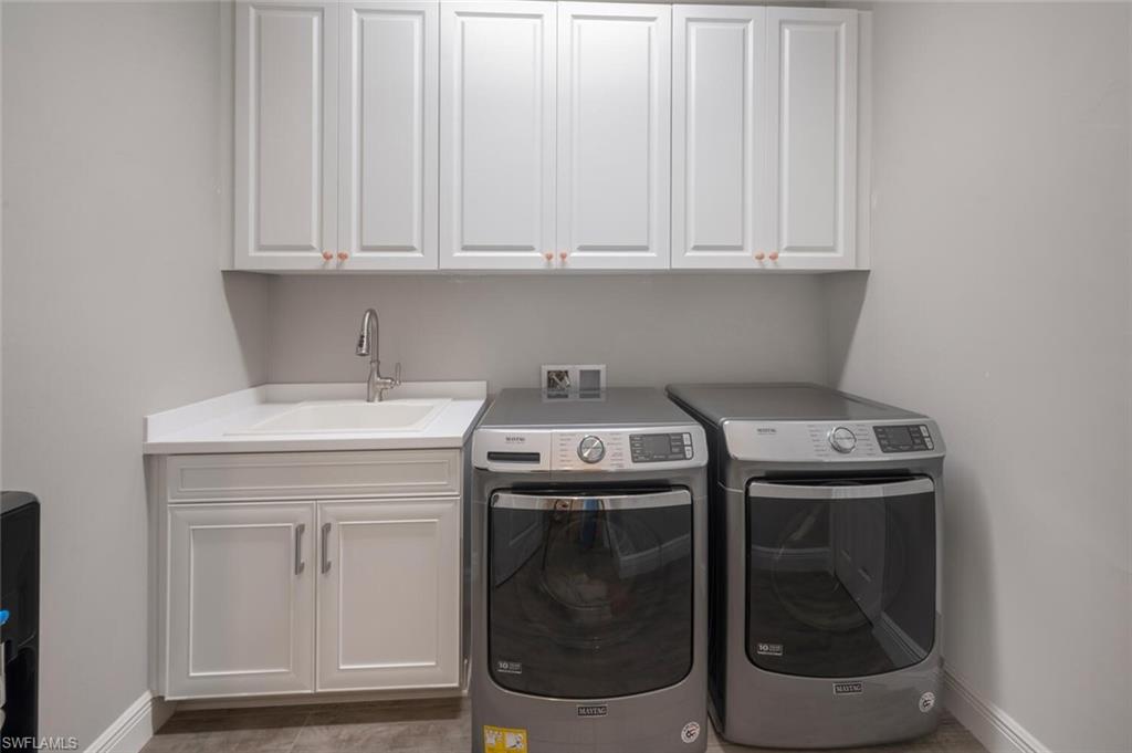 2167 Marquesa Circle Naples, FL 34112 - Photo 15 of 21 a utility room with dryer and washer