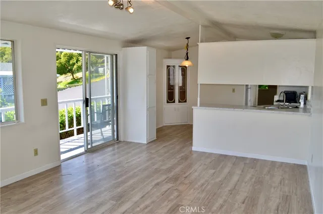a view of a kitchen with a sink microwave and a refrigerator