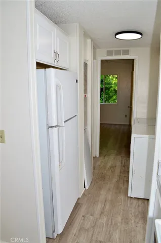 a view of a hallway with wooden floor and entryway