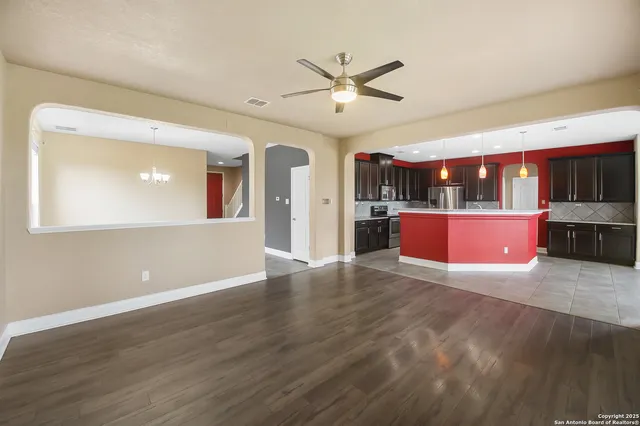 a kitchen with stainless steel appliances granite countertop a sink a stove and a refrigerator