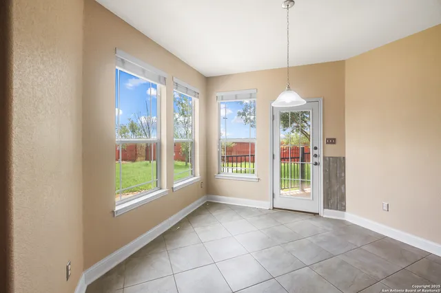 a large kitchen with granite countertop a large counter top and stainless steel appliances