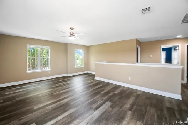a living room with furniture a rug and a lamp