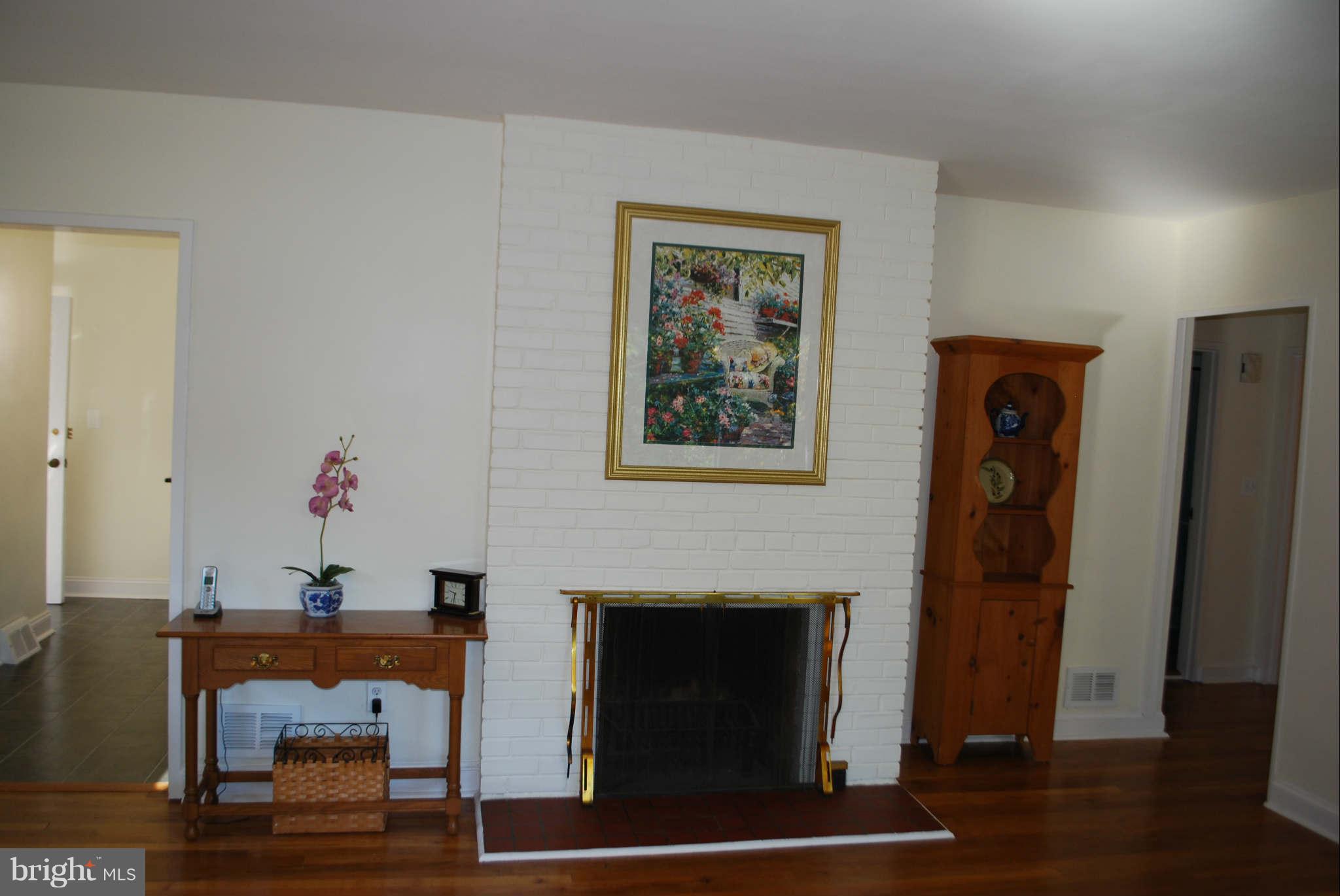 9018 Walden Road Silver Spring, MD 20901 - Photo 7 of 27 Living Room with Brick Fireplace