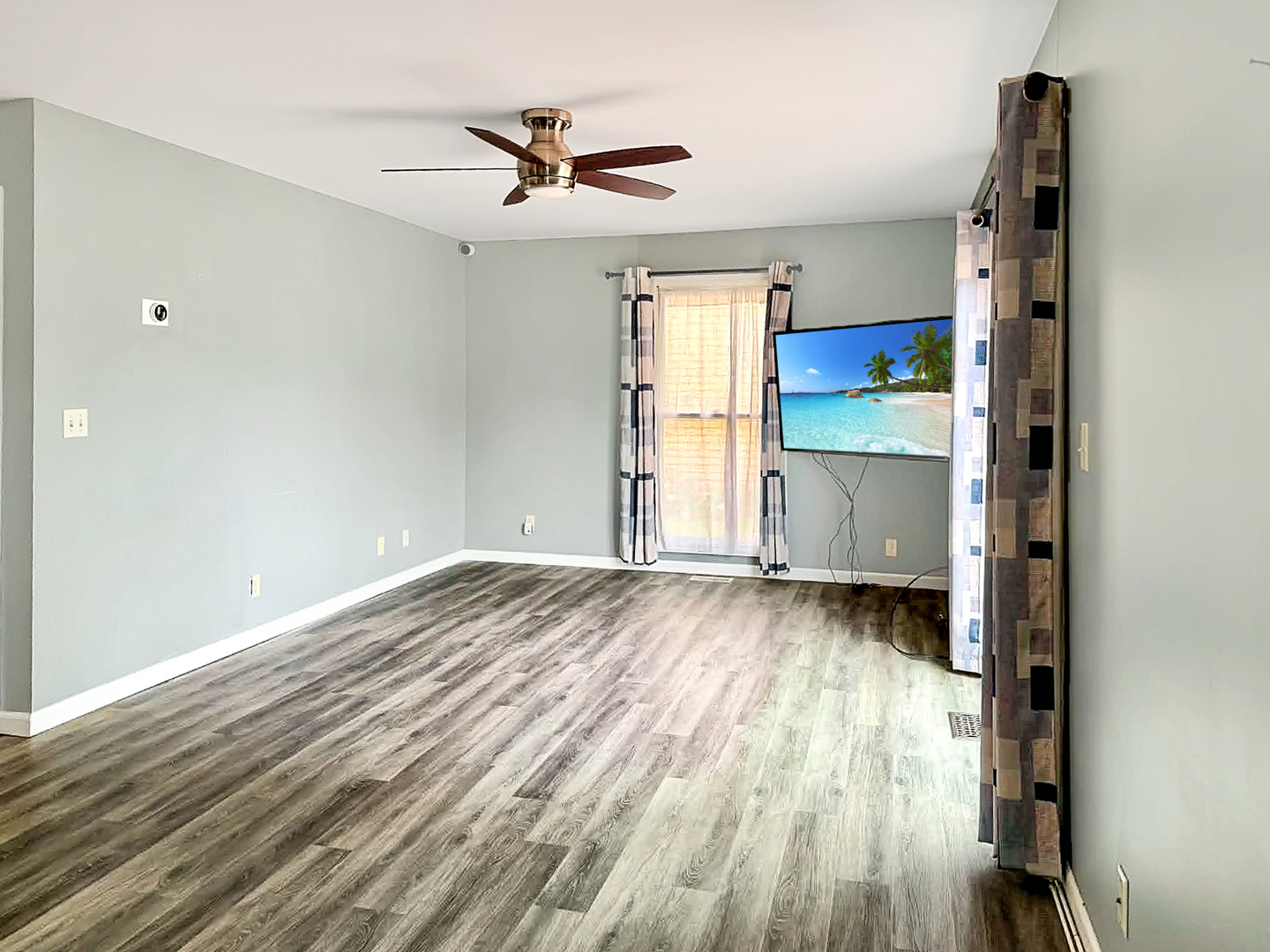 1008 Ascot Drive Rantoul, IL 61866 - Photo 6 of 24 a view of empty room with wooden floor and fan
