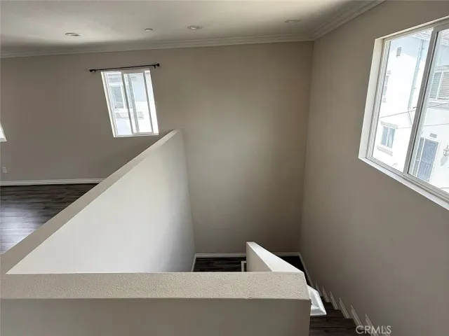 a view of staircase with white walls and window