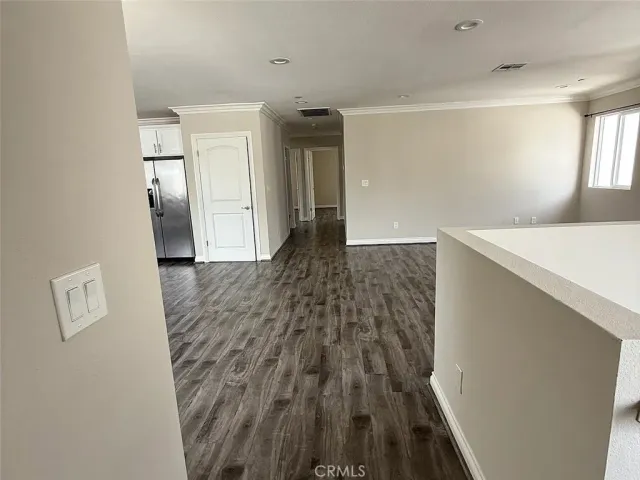 a view of hallway with wooden floor