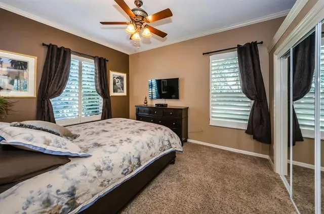 a bedroom with a large bed and a flat tv screen