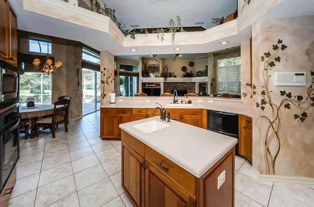 a kitchen with a sink a counter top space and appliances