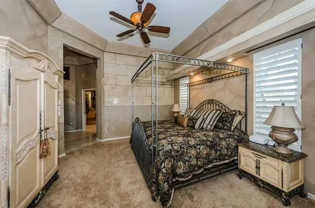 a bedroom with bed and a chandelier