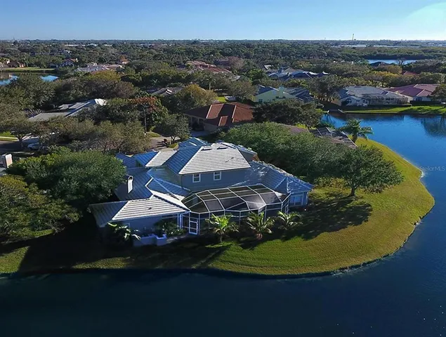 an aerial view of a house with outdoor space and lake view