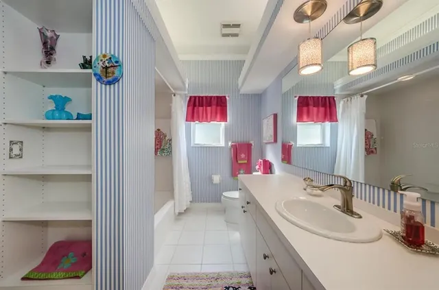 a bathroom with a sink vanity and a mirror