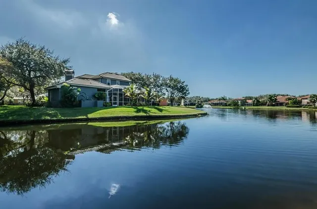 a view of a lake with houses in the back