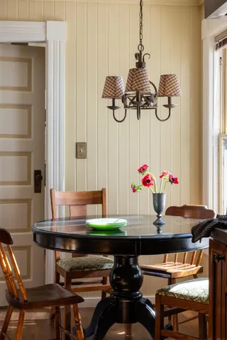a living room with a fireplace furniture and a potted plant