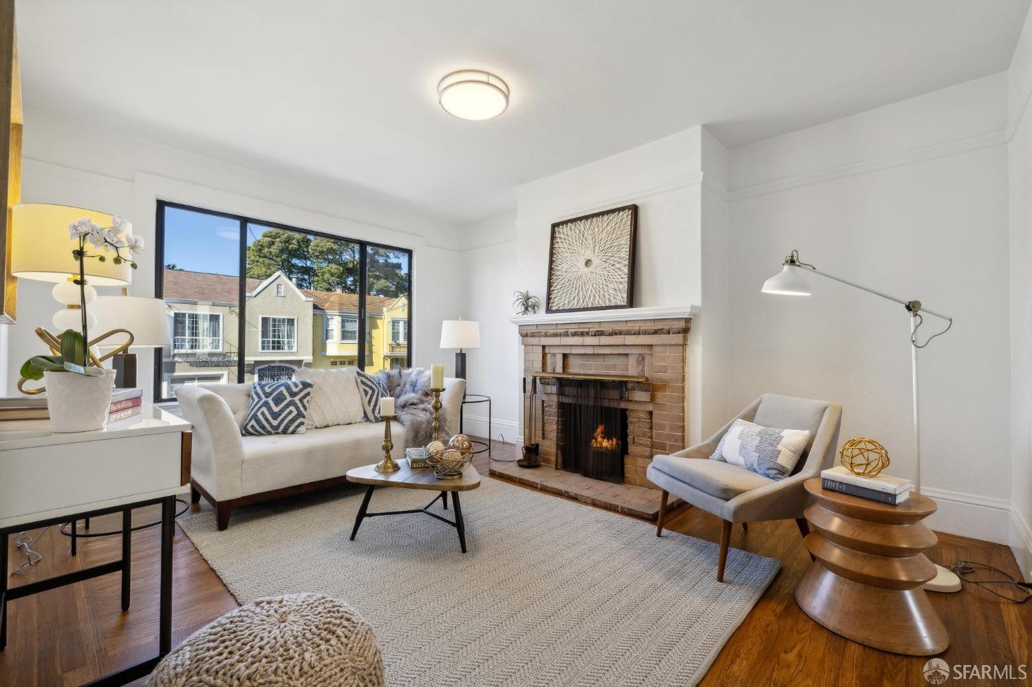 686 29th Avenue San Francisco, CA 94121 - Photo 12 of 69 a living room with furniture a rug and a fireplace