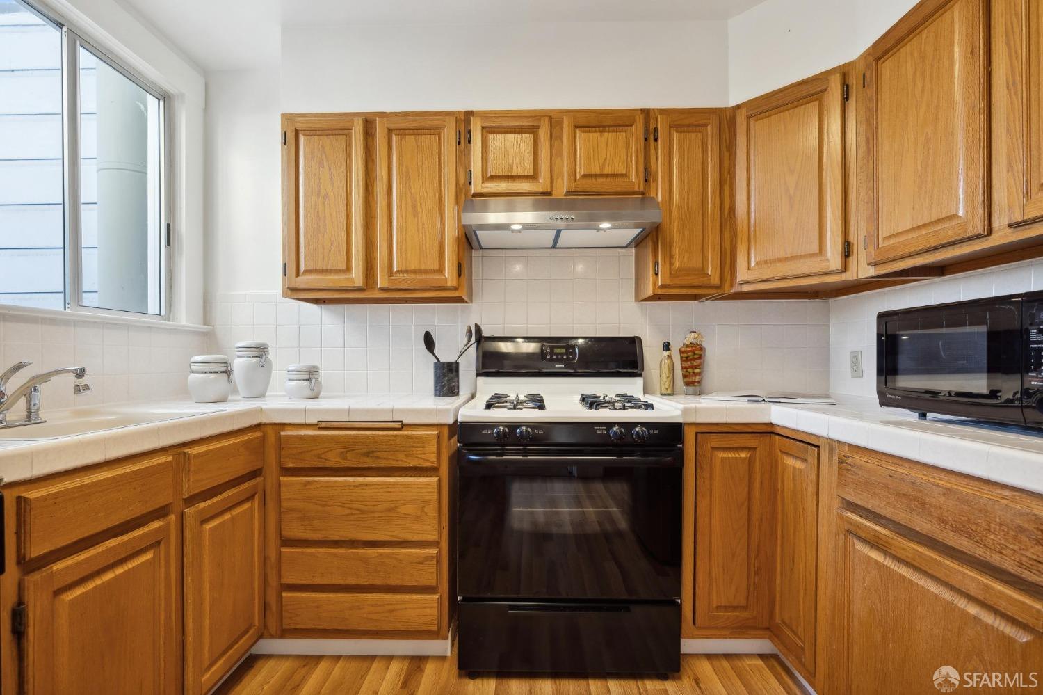 686 29th Avenue San Francisco, CA 94121 - Photo 37 of 69 a kitchen with stainless steel appliances granite countertop a sink stove and cabinets