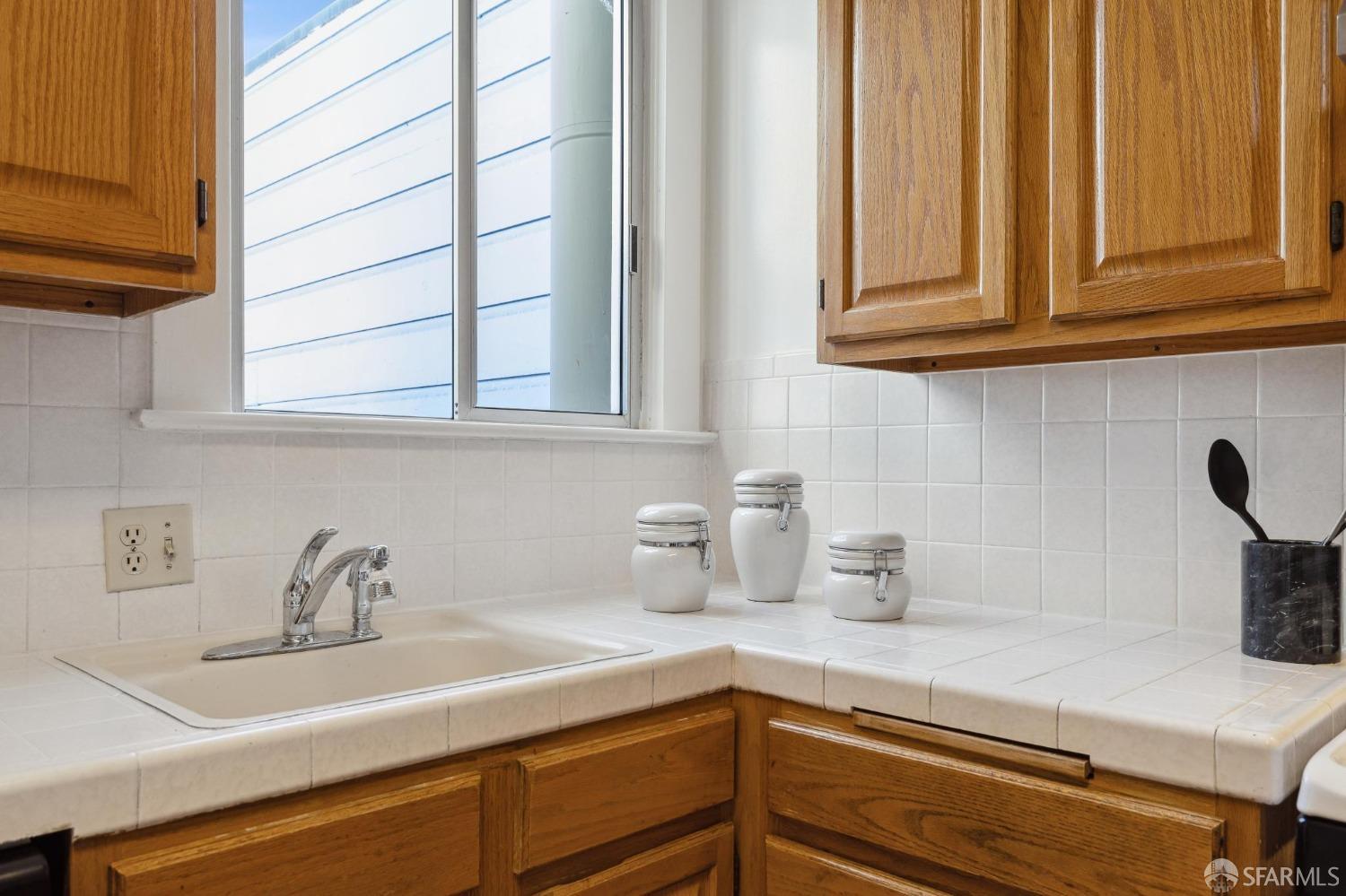 686 29th Avenue San Francisco, CA 94121 - Photo 40 of 69 a kitchen with stainless steel appliances granite countertop white cabinets and a sink