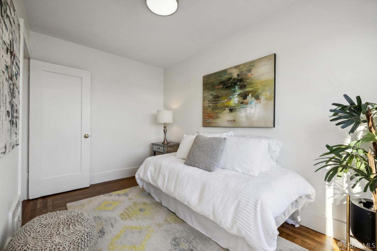 686 29th Avenue San Francisco, CA 94121 - Photo 49 of 69 a bedroom with a bed and a potted plant