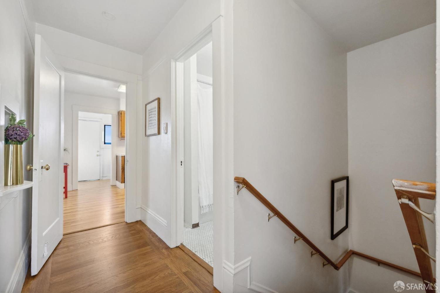 686 29th Avenue San Francisco, CA 94121 - Photo 10 of 69 a view of a hallway with wooden floor and staircase