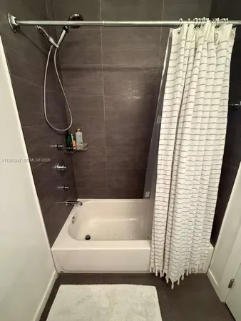 a bathroom with a bath tub and shower
