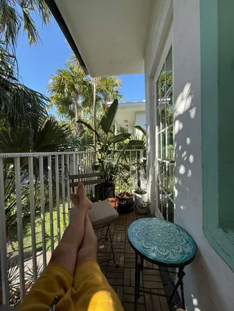 a balcony with table and chairs