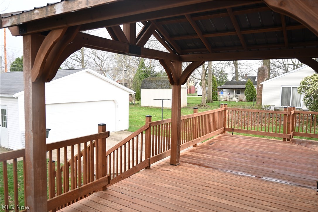 94 North 5th Street Rittman, OH 44270 - Photo 22 of 27 Wooden terrace with an outbuilding, a lawn, a gazebo, and a garage