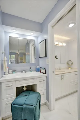 a bathroom with a double vanity sink mirror and