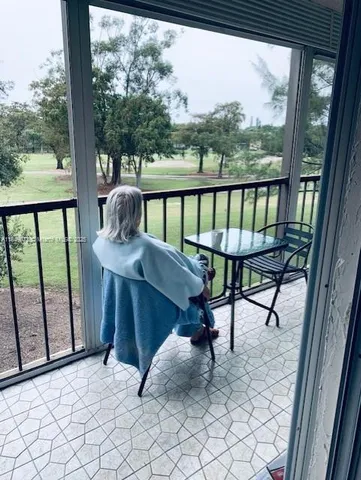 a hallway with a dining table and chandelier