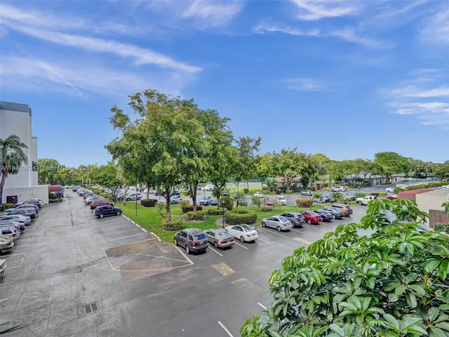 a view of a swimming pool and lounge chairs in back yard