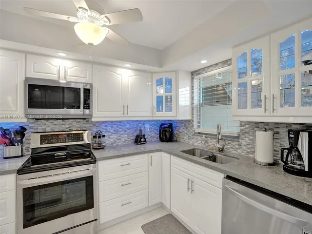 a kitchen with a sink stove and microwave