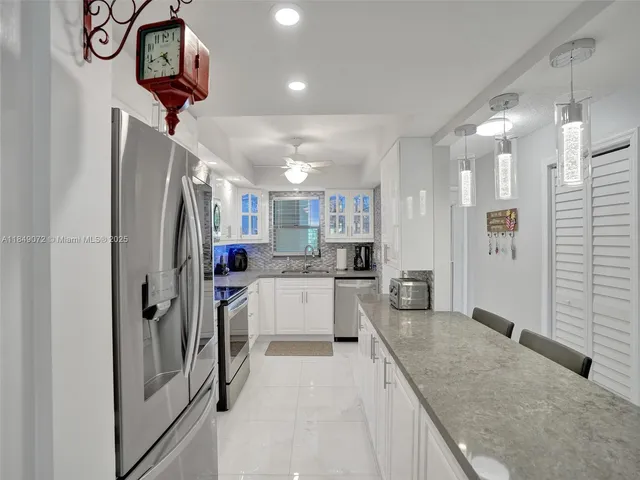a kitchen with refrigerator and window