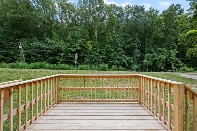 a view of deck with a large trees