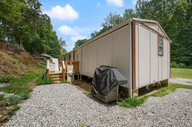 a view of a house with backyard and sitting area