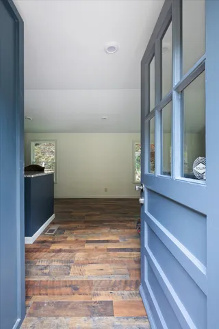 a view of room with a ceiling fan and wooden floor