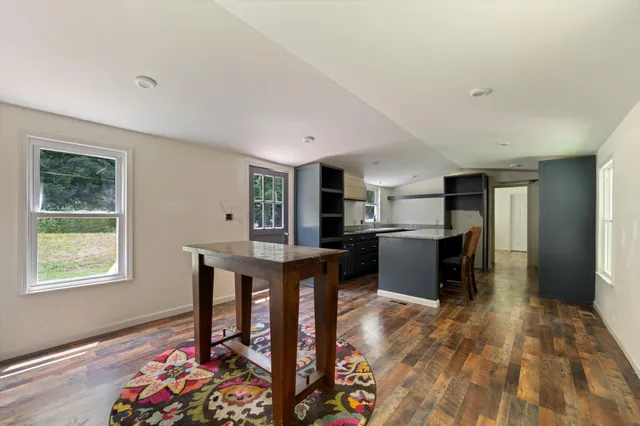 a kitchen with stainless steel appliances granite countertop a refrigerator and a stove top oven
