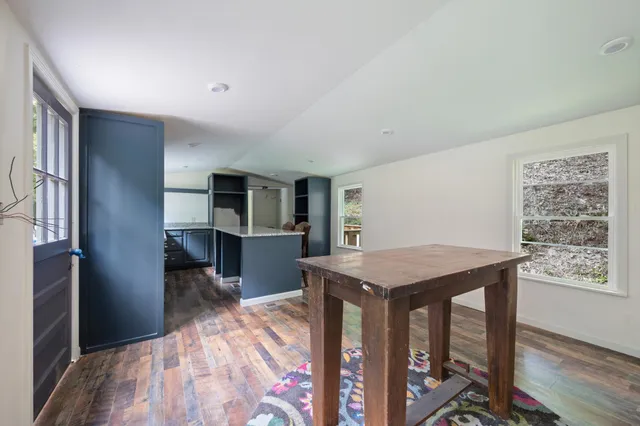 a view of a kitchen with cabinets and wooden floor