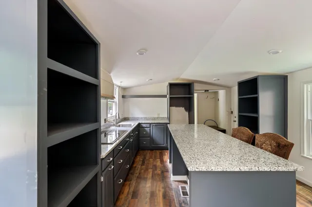 a kitchen with kitchen island granite countertop counter top space and stainless steel appliances
