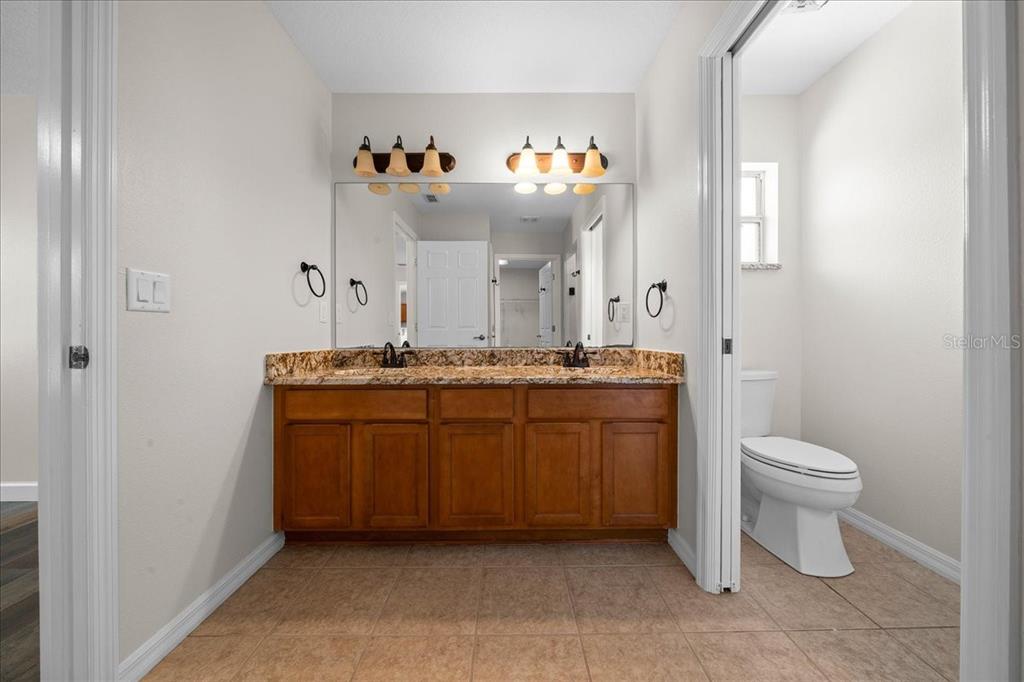 234 Locust Lane Ocala, FL 34472 - Photo 57 of 71 a bathroom with a toilet sink and mirror