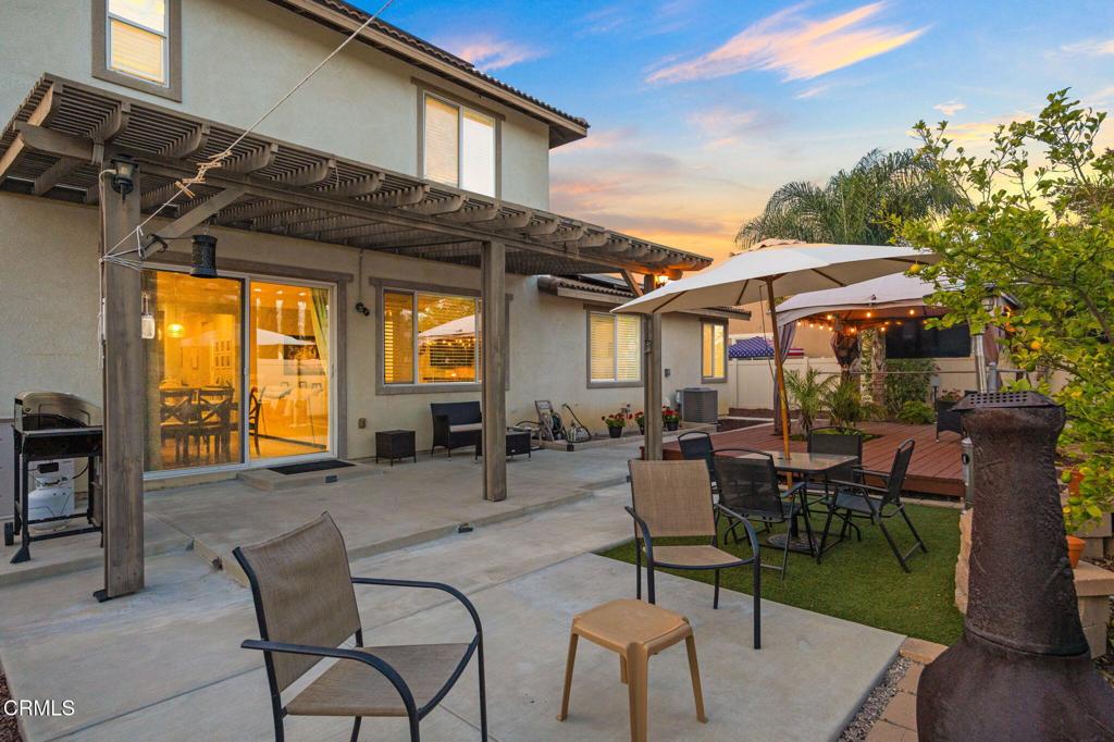 396 Edgewood Drive Fillmore, CA 93015 - Photo 27 of 37 a view of a patio with table and chairs under an umbrella