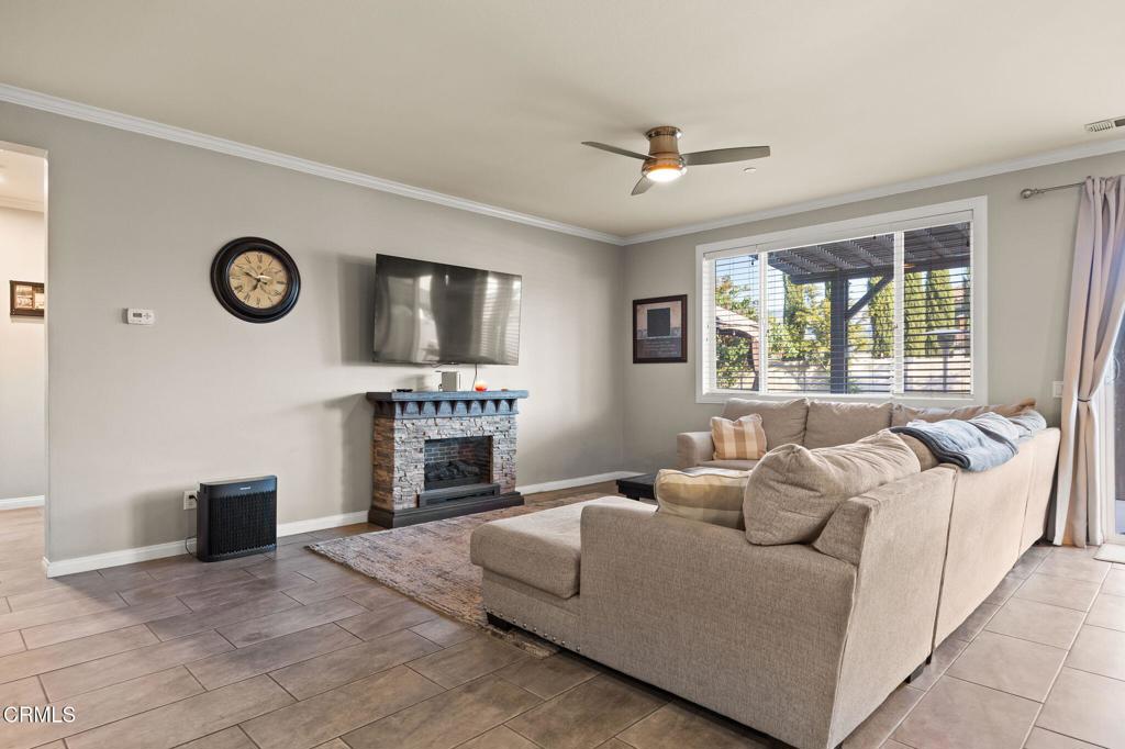 396 Edgewood Drive Fillmore, CA 93015 - Photo 6 of 37 a living room with furniture a fireplace and a flat screen tv