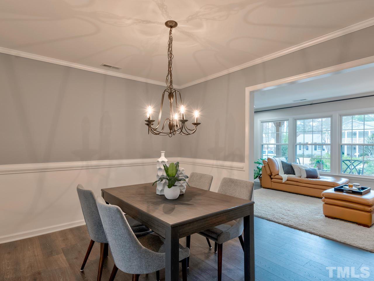 1000 Deerfield Road Raleigh, NC 27609 - Photo 8 of 30 A perfect place for family dinners. The dining room features chair rail molding and a chandelier.