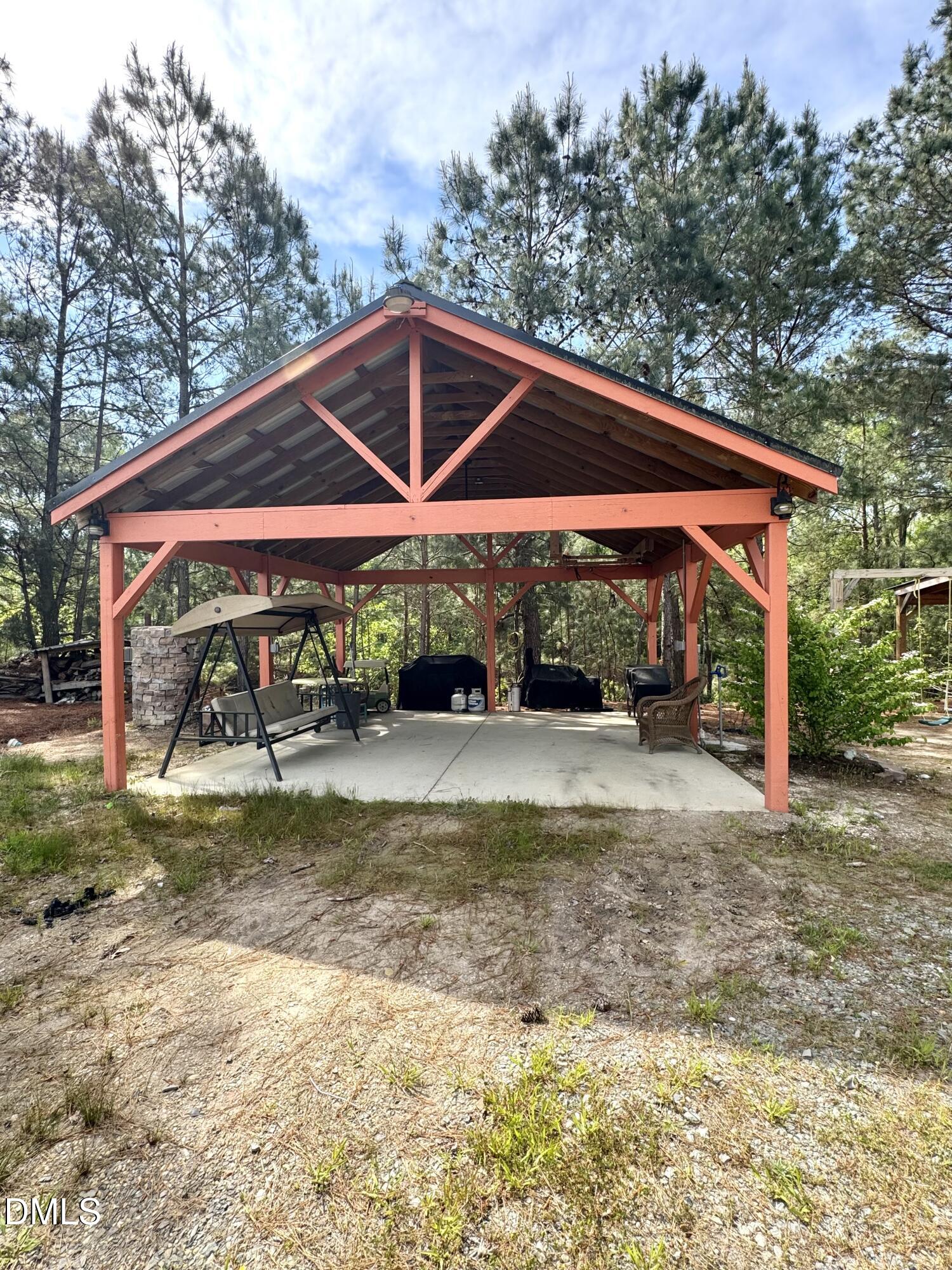 640 Tart Town Road Dunn, NC 28334 - Photo 65 of 71 a view of backyard with table and chairs under an umbrella