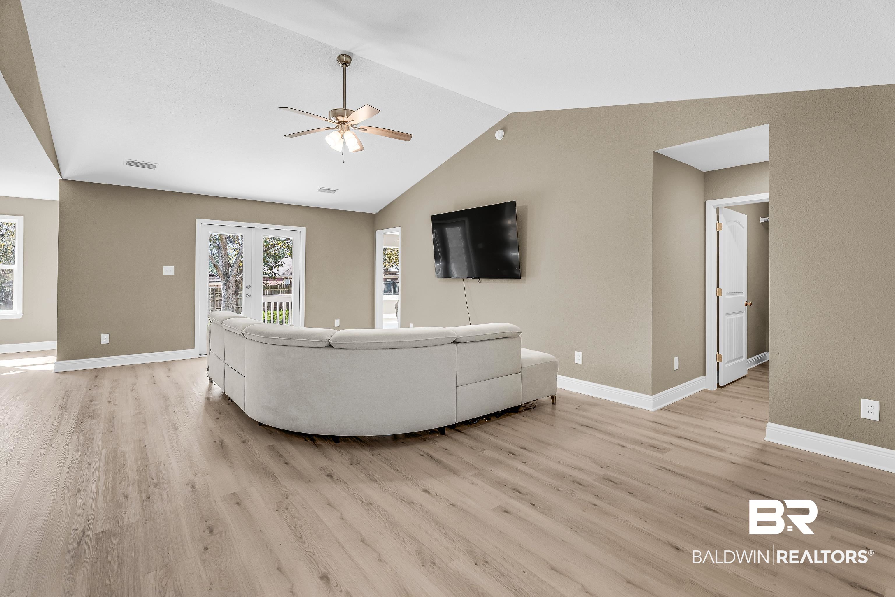 9206 Greenleaf Drive Daphne, AL 36527 - Photo 2 of 32 Living area featuring light wood-style floors, lofted ceiling, and ceiling fan