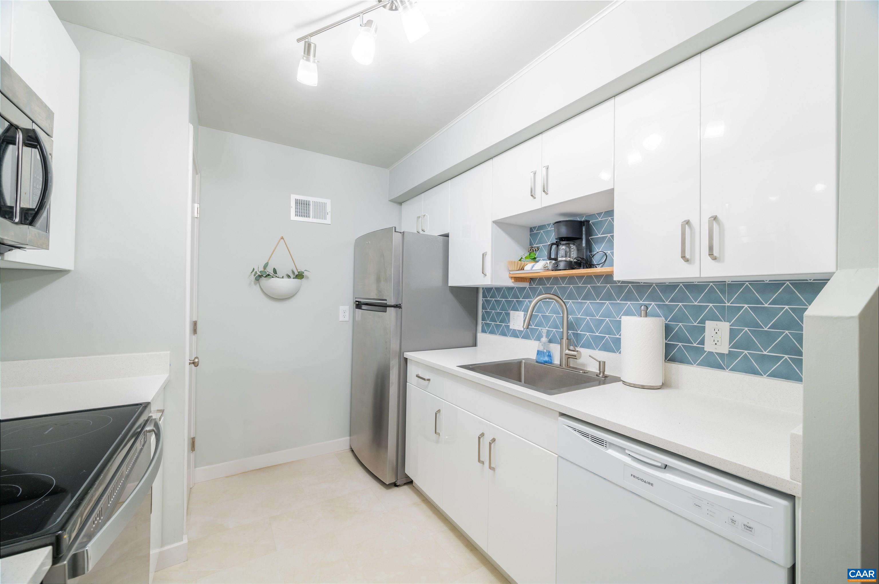134 Turtle Creek Road, Unit 4 Charlottesville, VA 22901 - Photo 14 of 19 a kitchen with a sink and a refrigerator