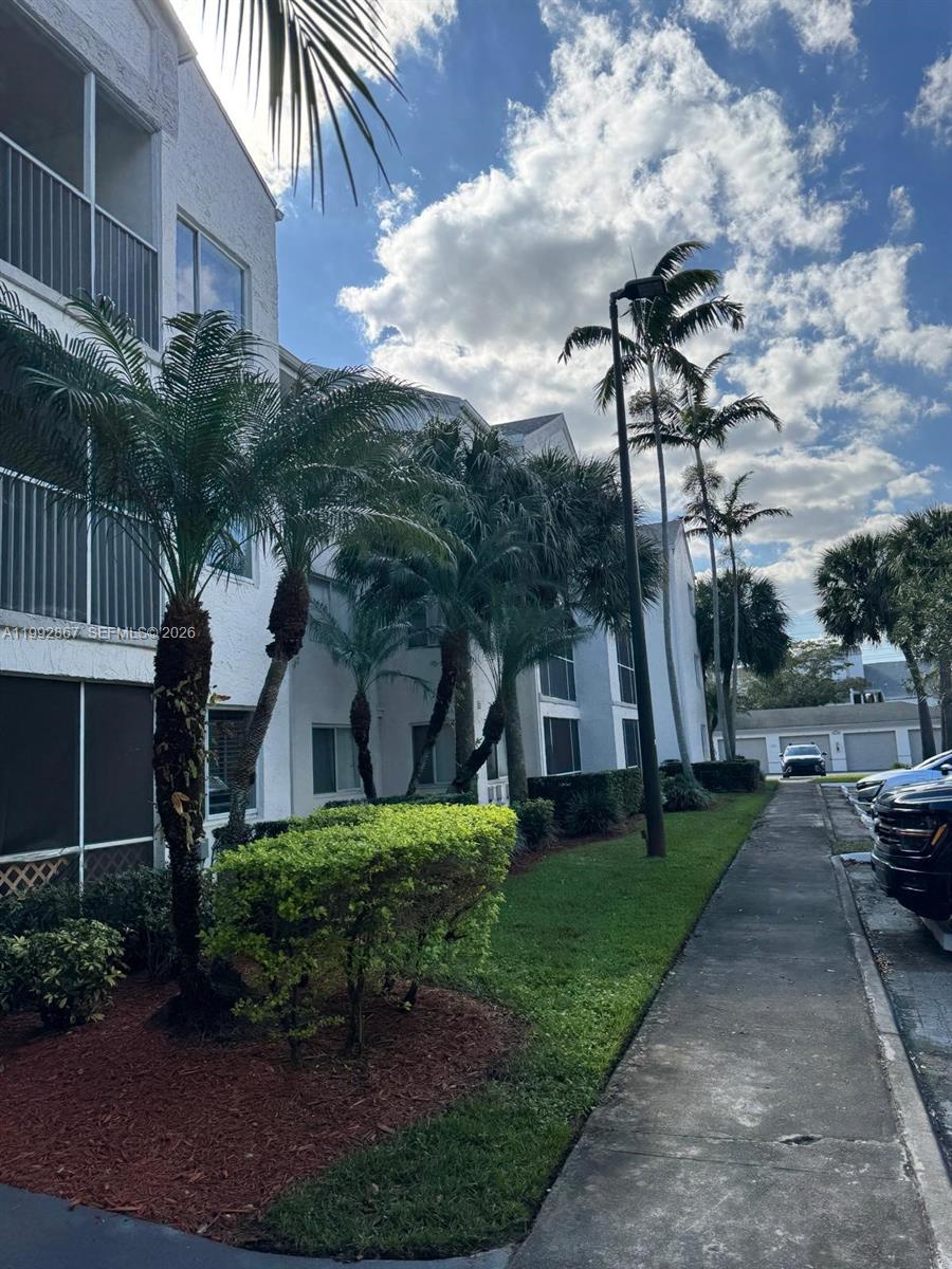 5760 Rock Island Road, Unit 304 Tamarac, FL 33319 - Photo 2 of 40 a view of a backyard with plants and a patio