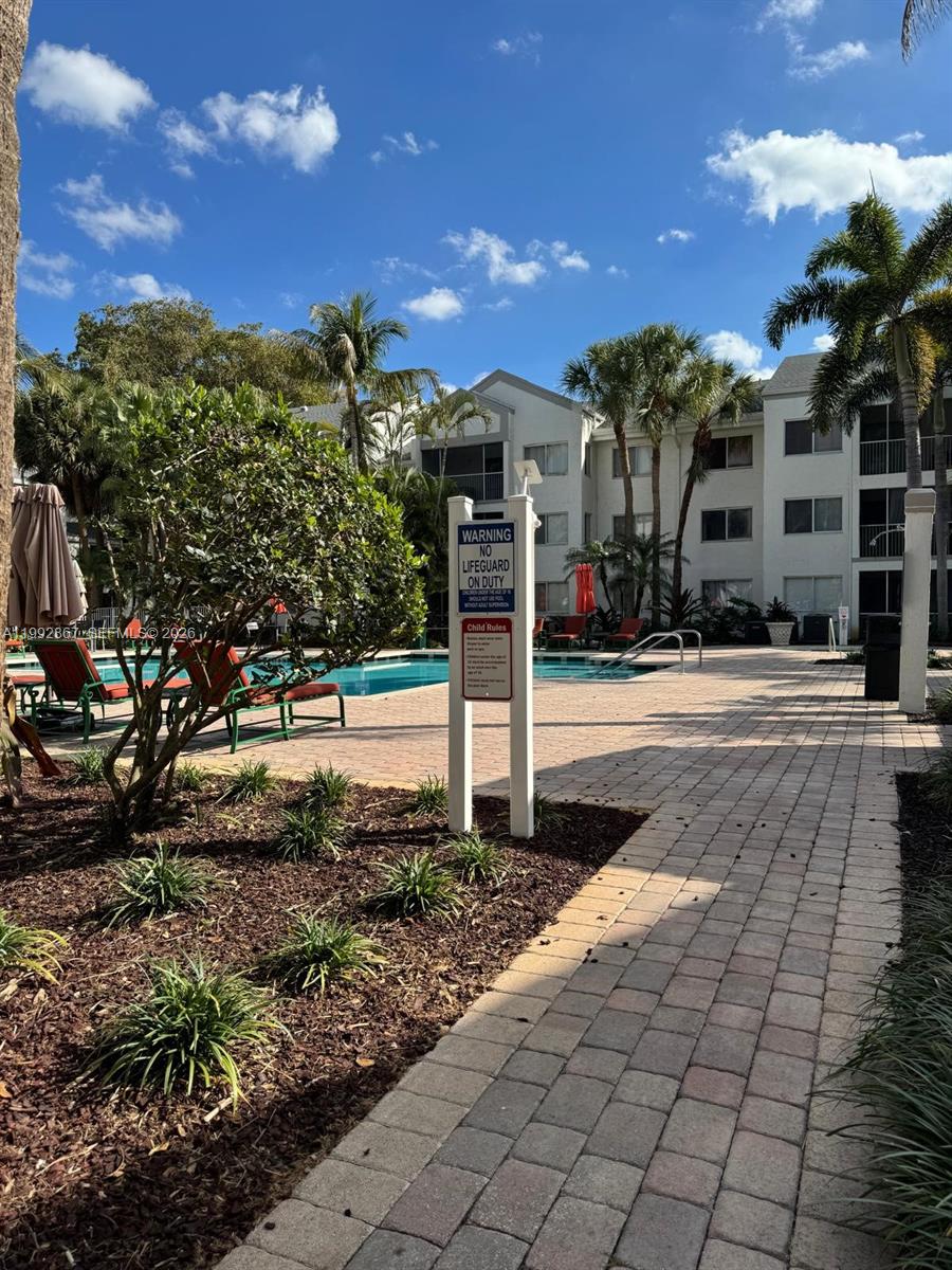 5760 Rock Island Road, Unit 304 Tamarac, FL 33319 - Photo 24 of 40 a view of a yard with plants and a fountain