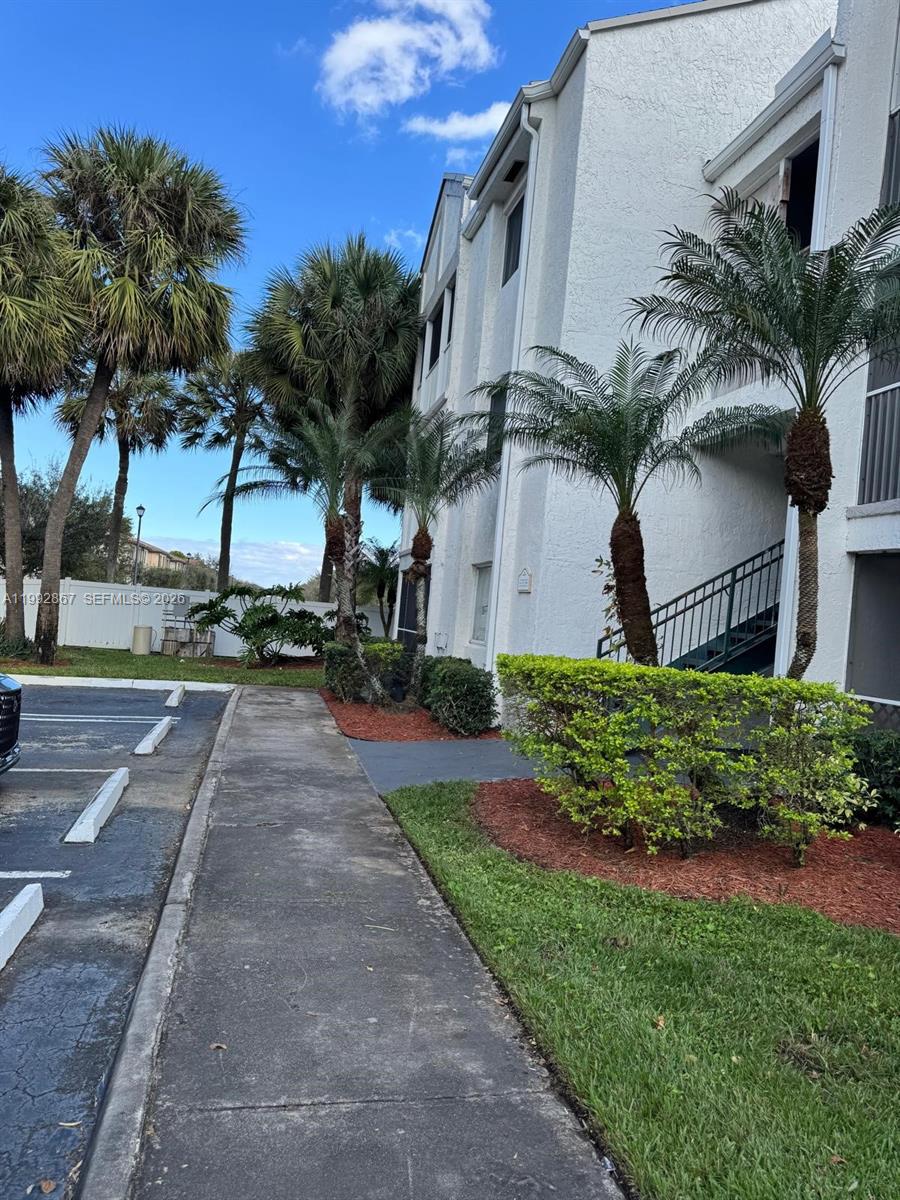 5760 Rock Island Road, Unit 304 Tamarac, FL 33319 - Photo 29 of 40 a front view of a house with garden